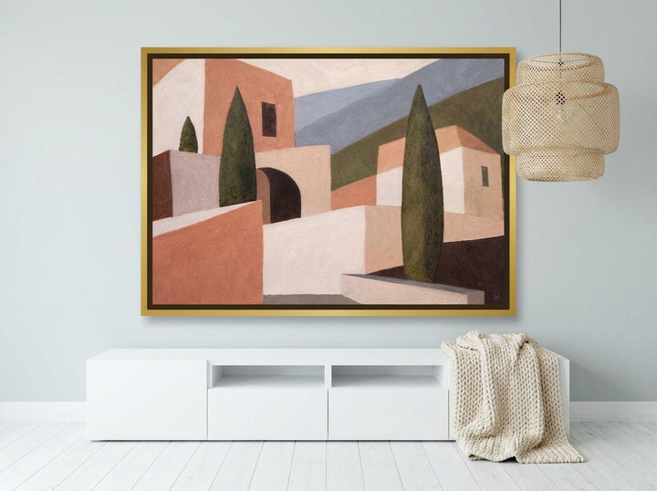 Canvas wall art with a gold leaf surround styled on the wall in a bright Scandinavian living room