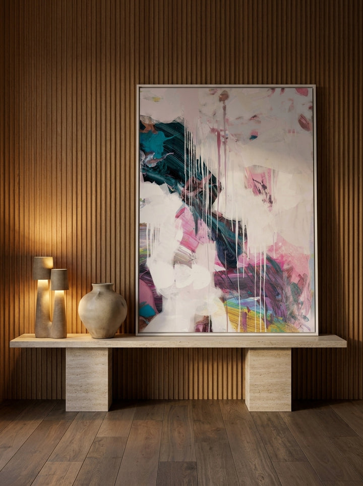 Canvas wall art with a white surround standing on a console in a luxe dining room