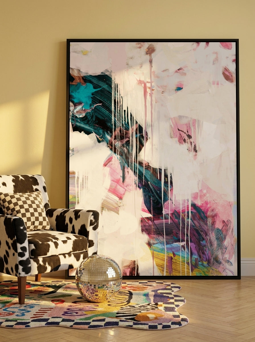 Oversized statement canvas wall art with a black surround leaning against the wall in a colourful eclectic bedroom
