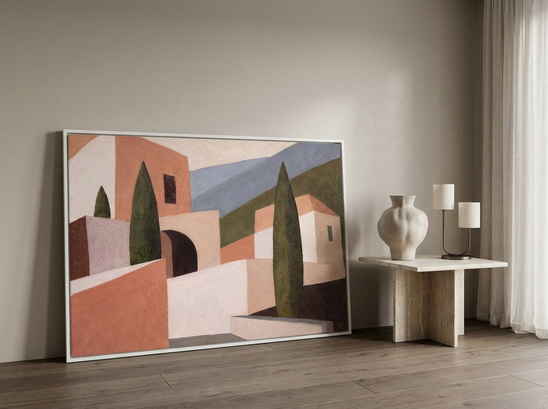 Oversized statement canvas wall art with a white surround leaning against the wall in a luxe dining room
