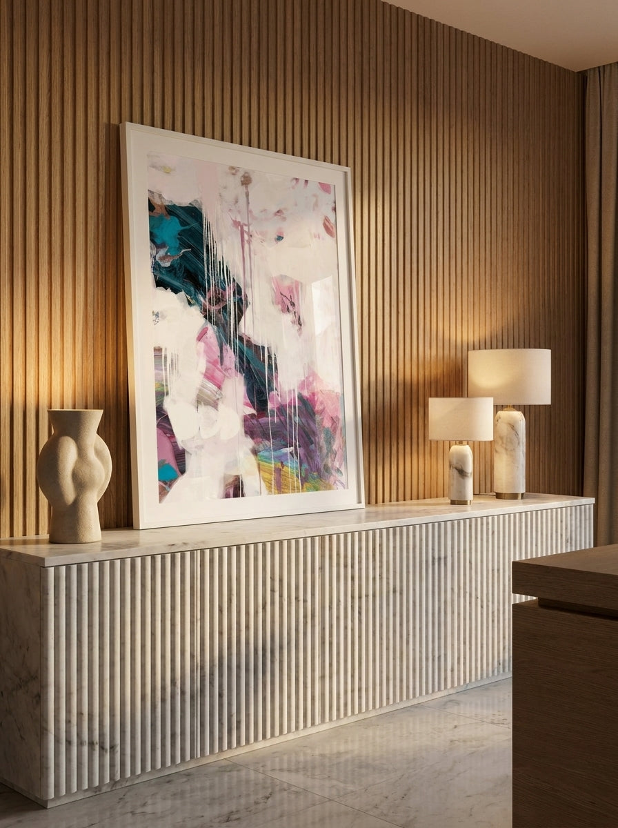 Modern wall art print standing on a sideboard in a luxe home office