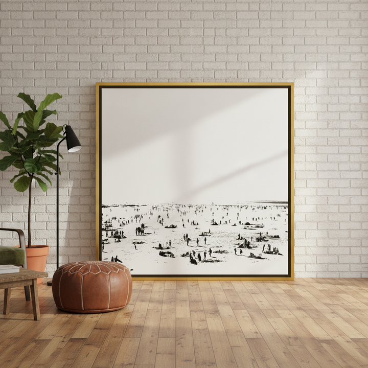 Oversized statement canvas wall art with a gold leaf surround leaning against the wall in an industrial loft living room