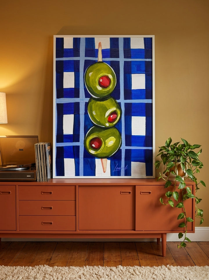 Modern wall art print standing on a sideboard in a retro 70s dining room