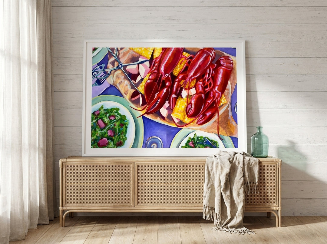 Modern wall art print standing on a sideboard in a coastal bedroom