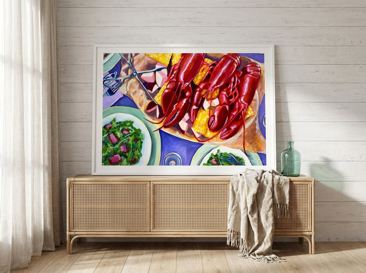 Modern wall art print standing on a sideboard in a coastal bedroom