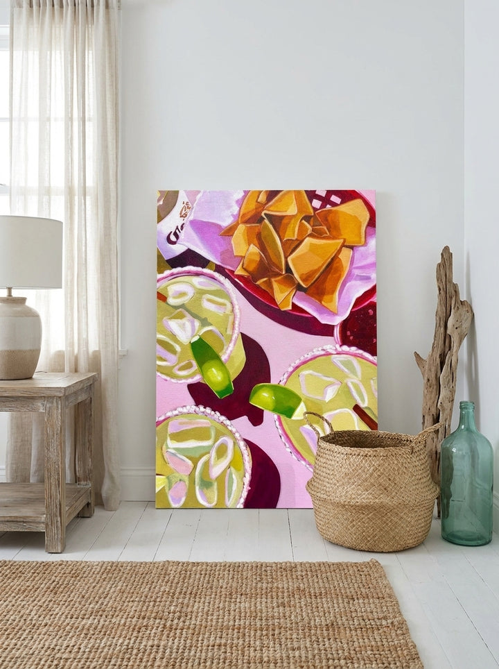 Stretched canvas wall art leaning against the wall in a coastal living room