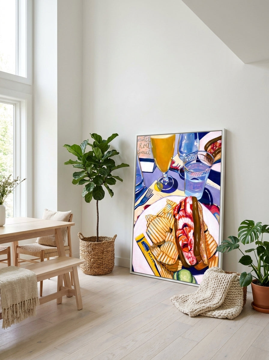 Oversized statement canvas wall art with a white surround leaning against the wall in a bright Scandinavian dining room