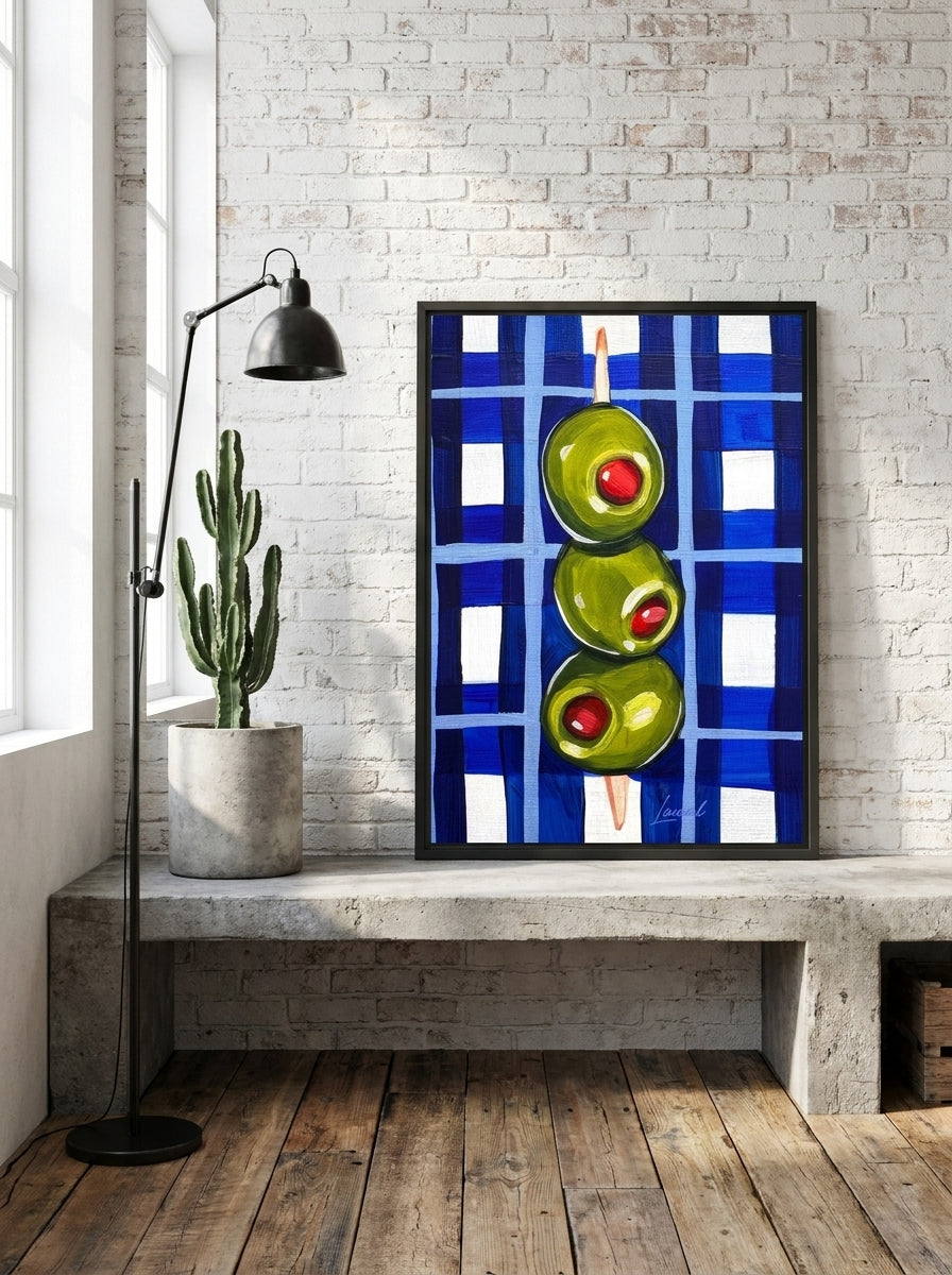 Canvas wall art with a black surround standing on a kitchen bench in an industrial loft kitchen