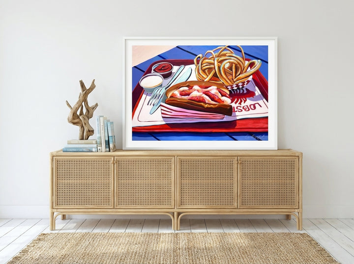 Modern wall art print standing on a sideboard in a coastal bedroom