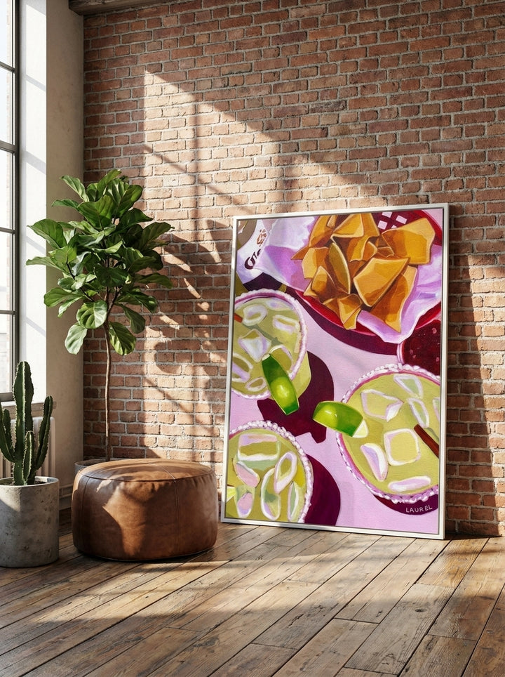 Oversized statement canvas wall art with a white surround leaning against the wall in an industrial loft dining room