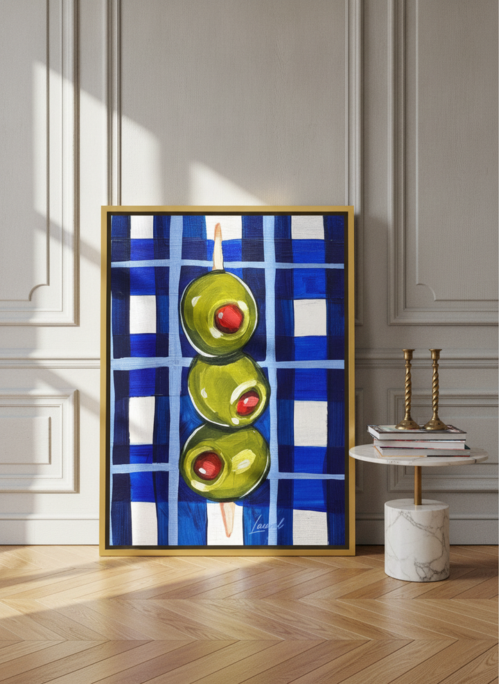 Canvas wall art with a gold leaf surround leaning against the wall in a Parisian living room