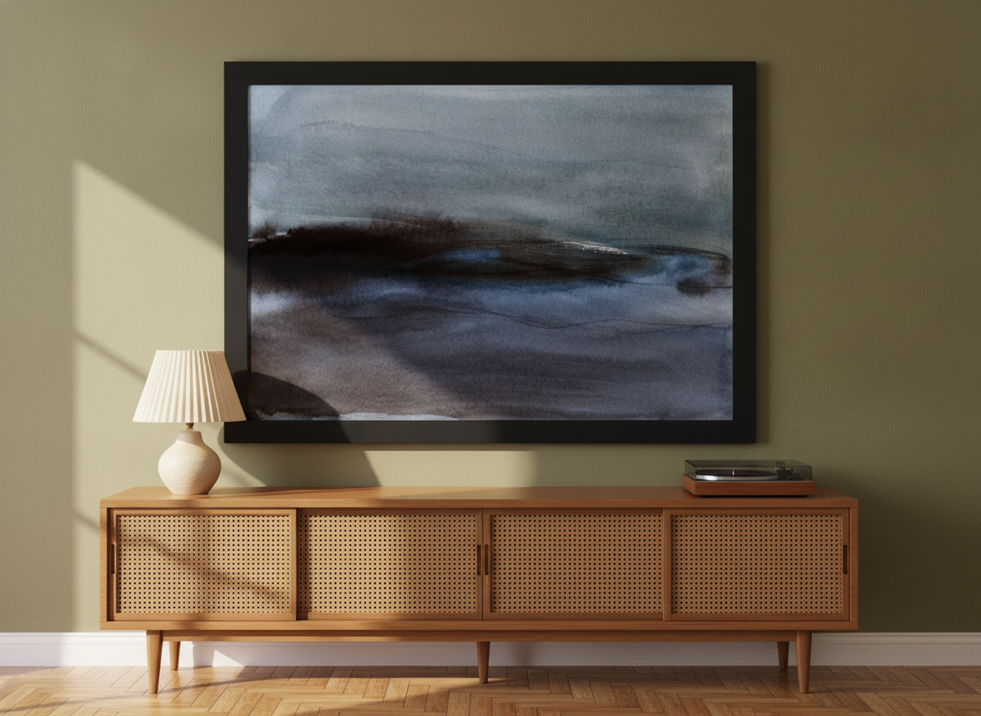 Modern wall art print standing on a sideboard in a mid-century bedroom