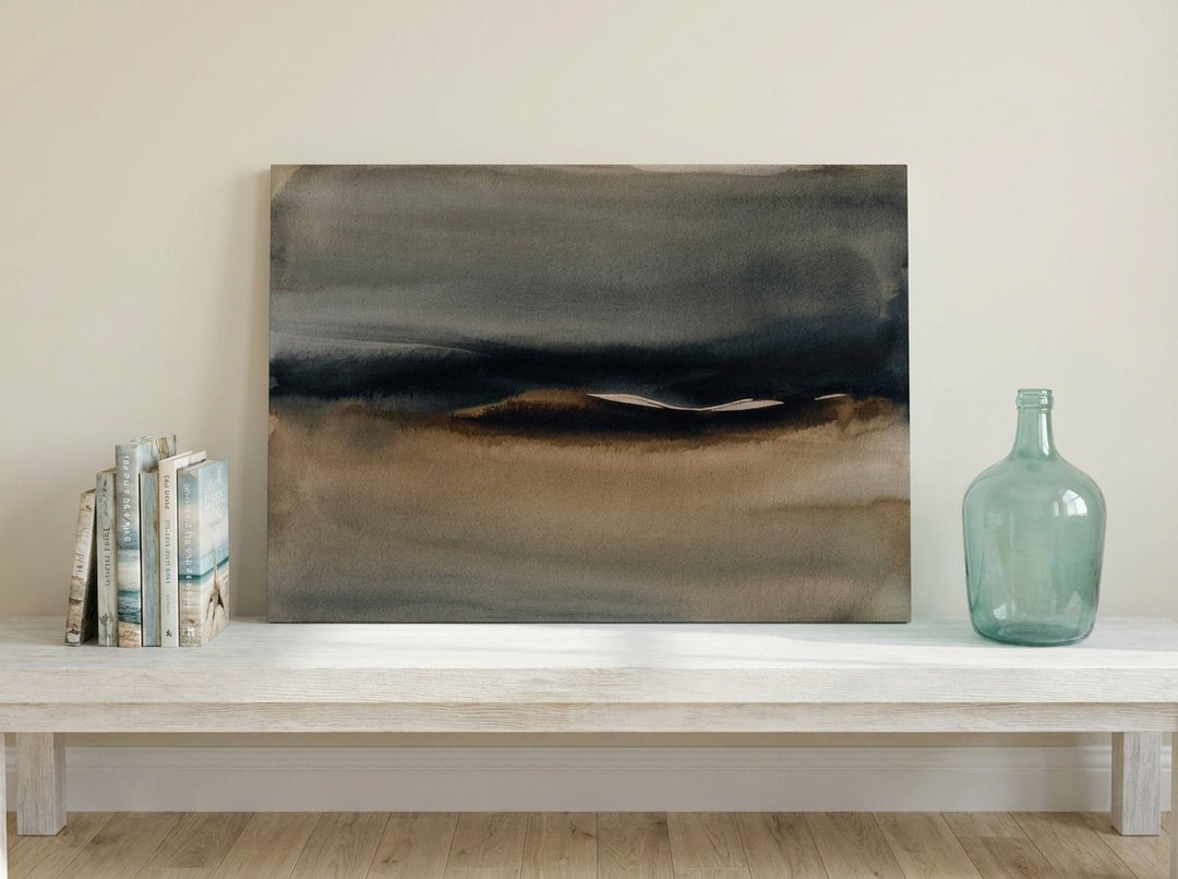 Stretched canvas wall art standing on a console in a coastal home office