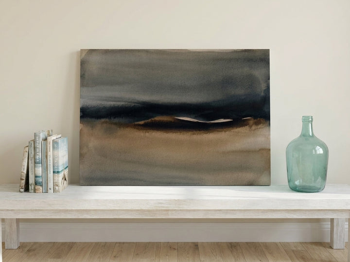 Stretched canvas wall art standing on a console in a coastal home office