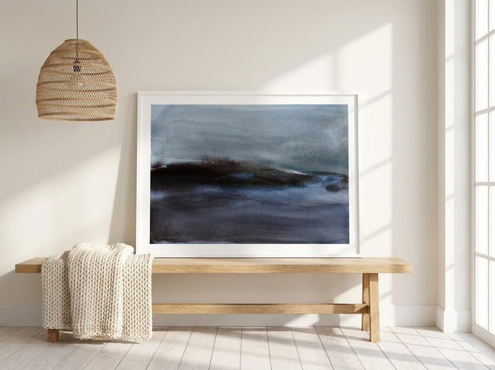 Modern wall art print standing on a bench in a bright Scandinavian living room