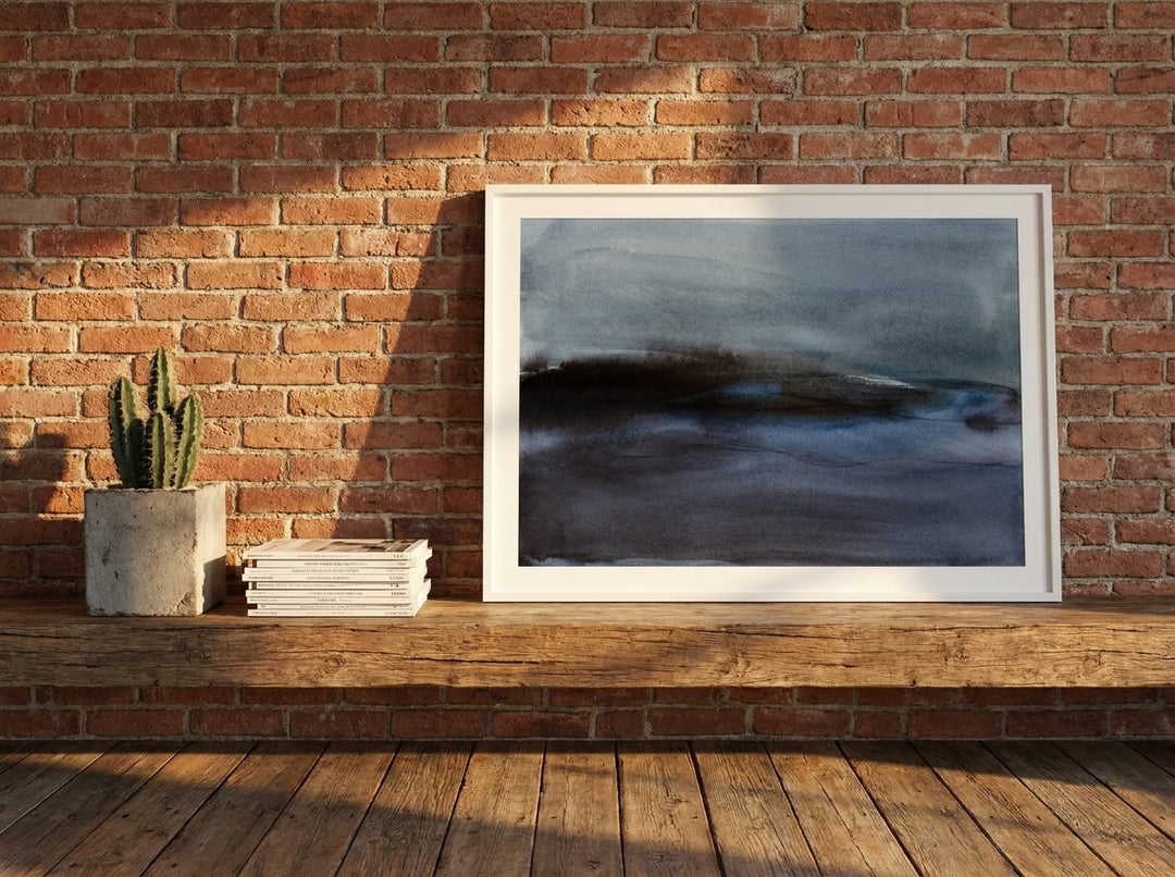 Modern wall art print standing on a bench in an industrial loft home office