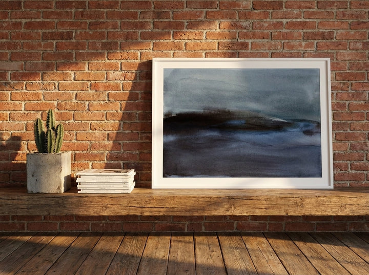 Modern wall art print standing on a bench in an industrial loft home office