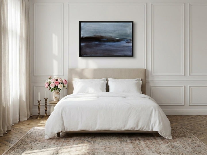 Canvas wall art with a black surround styled on the wall in a Parisian bedroom