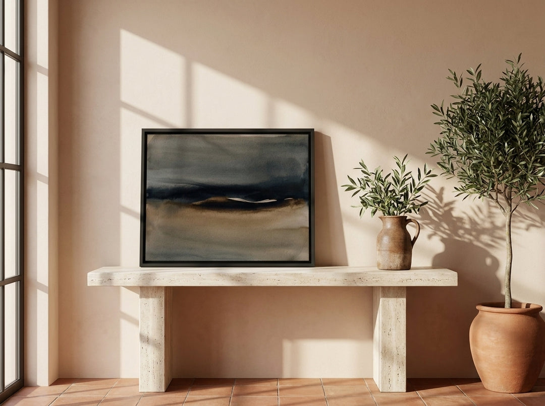 Canvas wall art with a black surround standing on a console in a Mediterranean living room