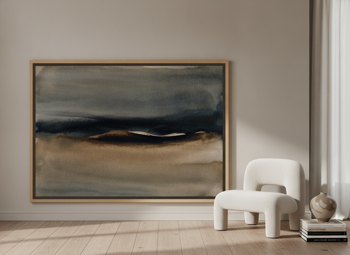 Oversized statement canvas wall art with a natural timber surround leaning against the wall in a luxe living room