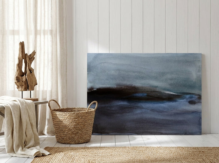 Stretched canvas wall art leaning against the wall in a coastal home office