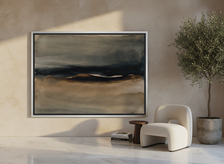 Oversized statement canvas wall art with a silver leaf surround leaning against the wall in a luxe dining room