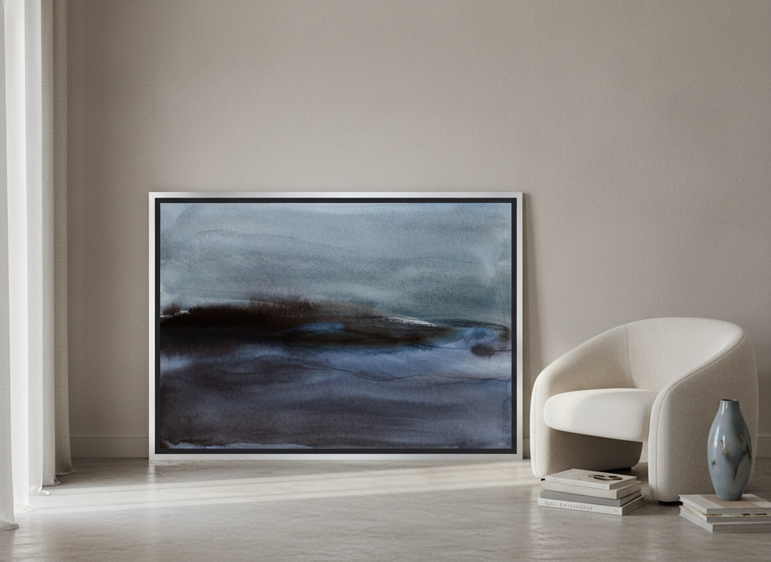 Canvas wall art with a silver leaf surround leaning against the wall in a luxe dining room