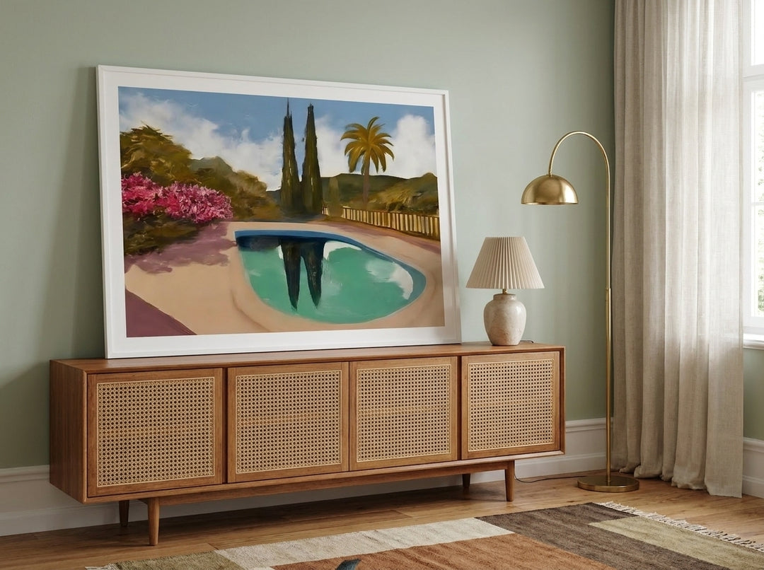 Modern wall art print standing on a sideboard in a mid-century living room