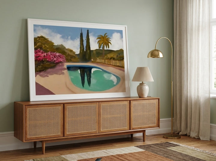 Modern wall art print standing on a sideboard in a mid-century living room