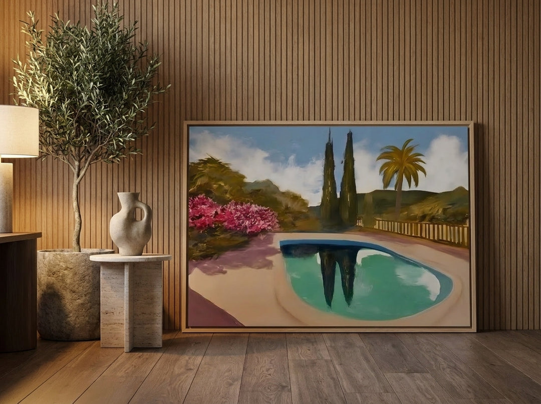 Oversized statement canvas wall art with a natural timber surround leaning against the wall in a luxe dining room