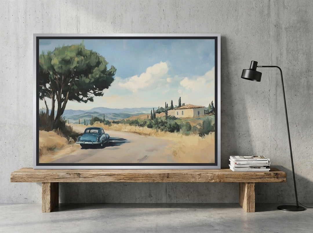 Canvas wall art with a silver leaf surround standing on a bench in an industrial loft home office