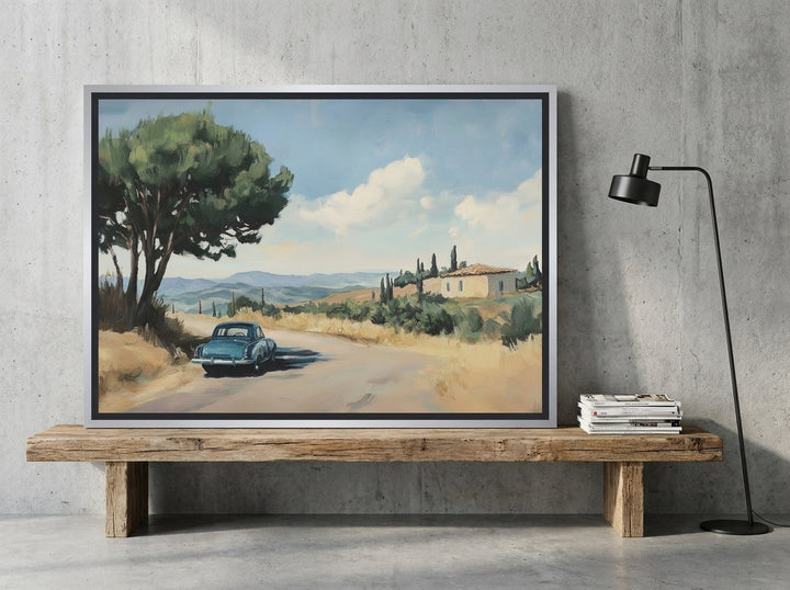 Canvas wall art with a silver leaf surround standing on a bench in an industrial loft home office