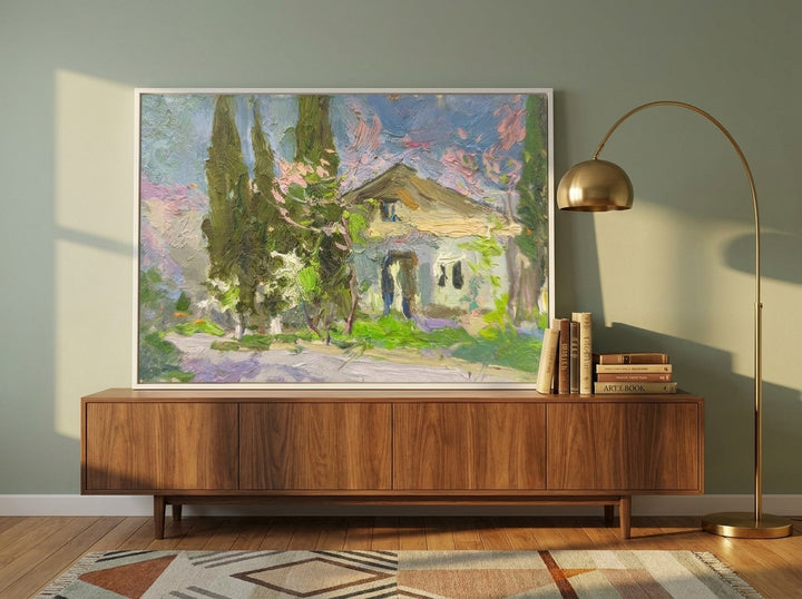 Canvas wall art with a white surround standing on a sideboard in a mid-century dining room