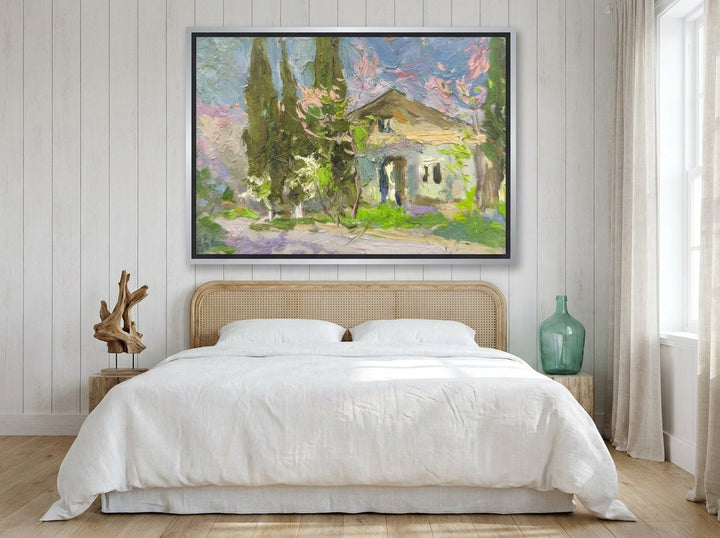 Canvas wall art with a silver leaf surround styled on the wall in a coastal bedroom