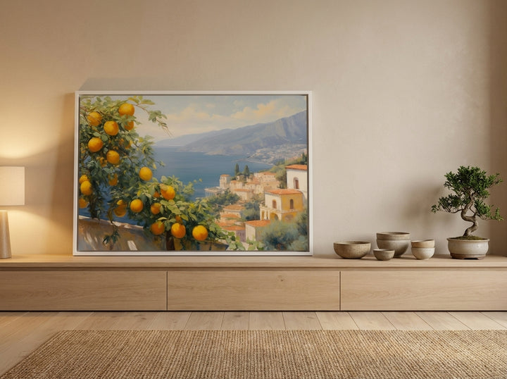 Canvas wall art with a white surround standing on a sideboard in a warm Japandi bedroom