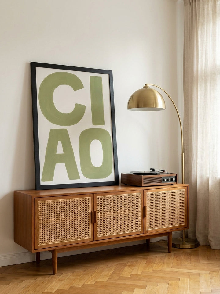 Modern wall art print standing on a sideboard in a mid-century home office