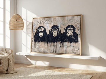 Canvas wall art with a natural timber surround standing on a shelf in a bright Scandinavian home office