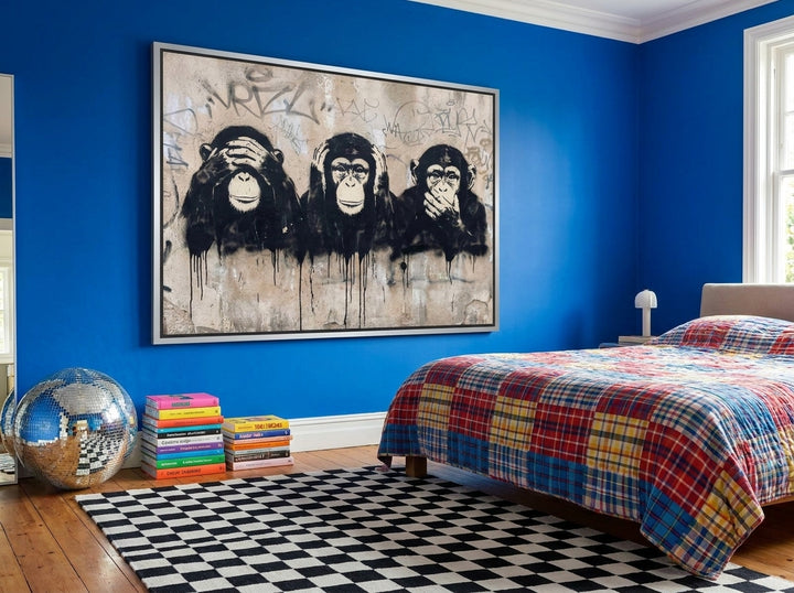 Oversized statement canvas wall art with a silver leaf surround styled on the wall in a colourful eclectic bedroom