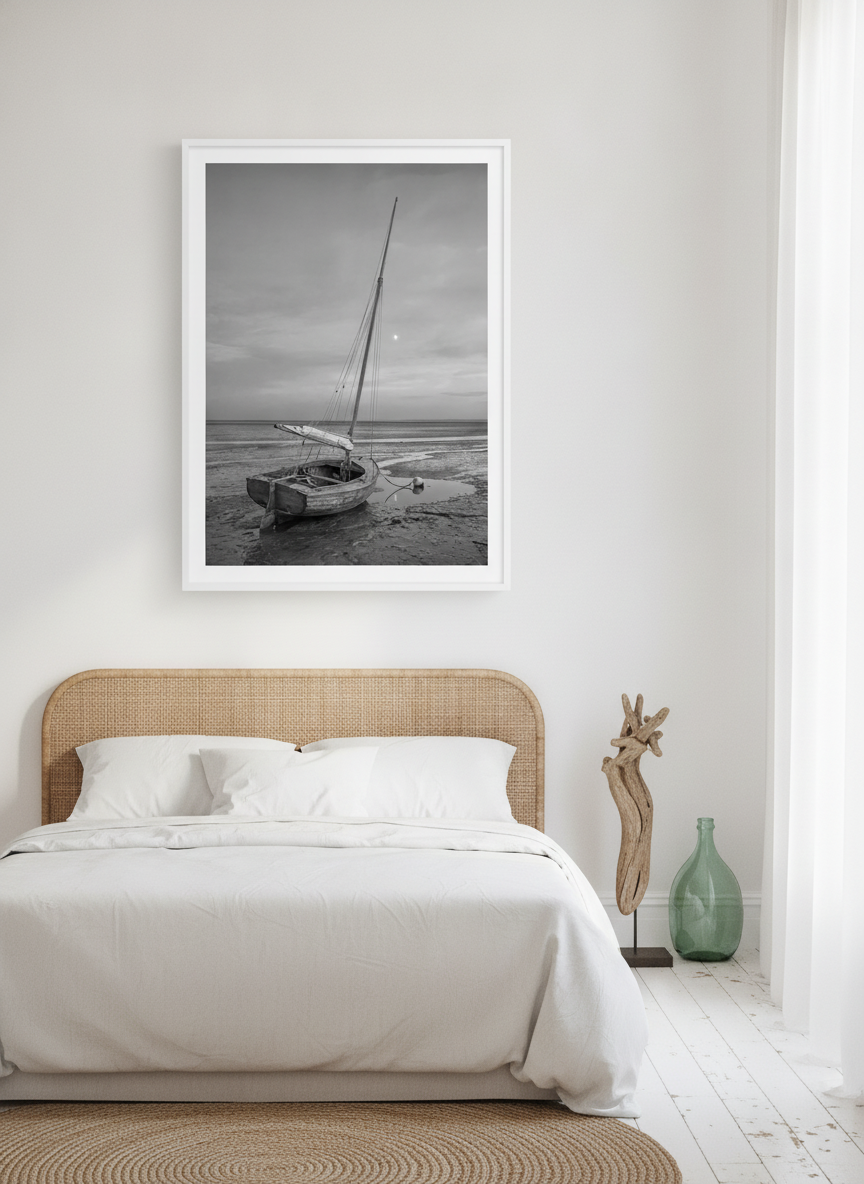 Oversized statement modern wall art print styled on the wall in a coastal bedroom