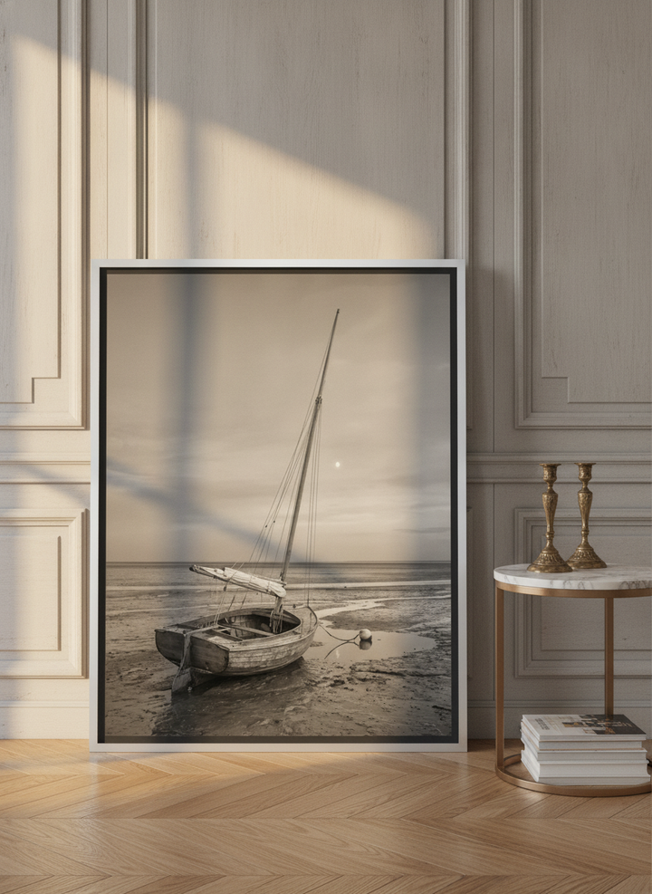 Canvas wall art with a silver leaf surround leaning against the wall in a Parisian home office