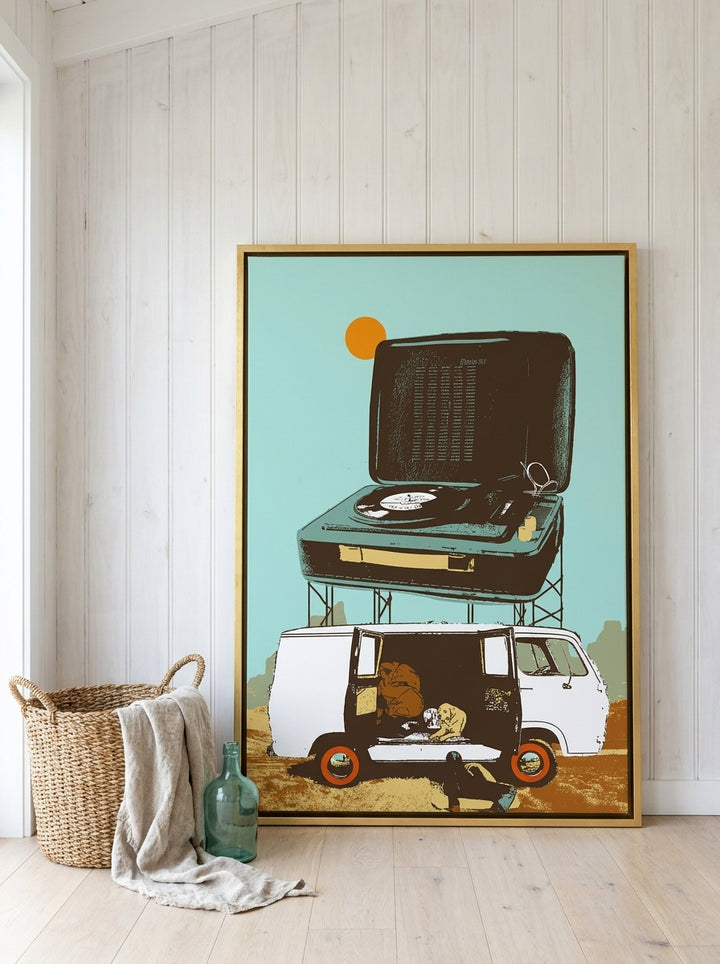 Oversized statement canvas wall art with a gold leaf surround leaning against the wall in a coastal home office