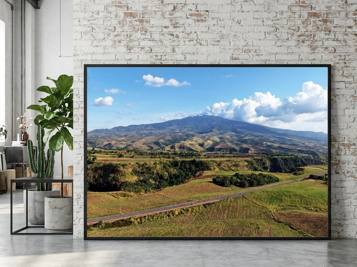 Oversized statement modern wall art print leaning against the wall in an industrial loft living room