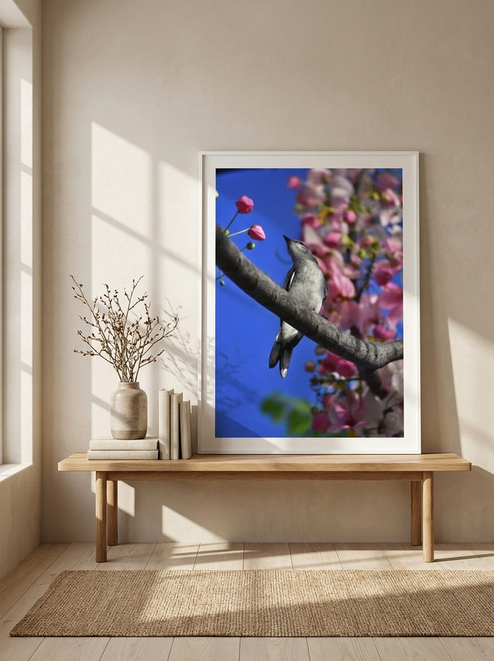 Modern wall art print standing on a bench in a warm Japandi bathroom