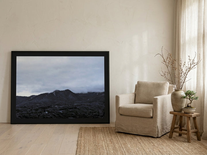 Oversized statement modern wall art print leaning against the wall in a warm Japandi bedroom