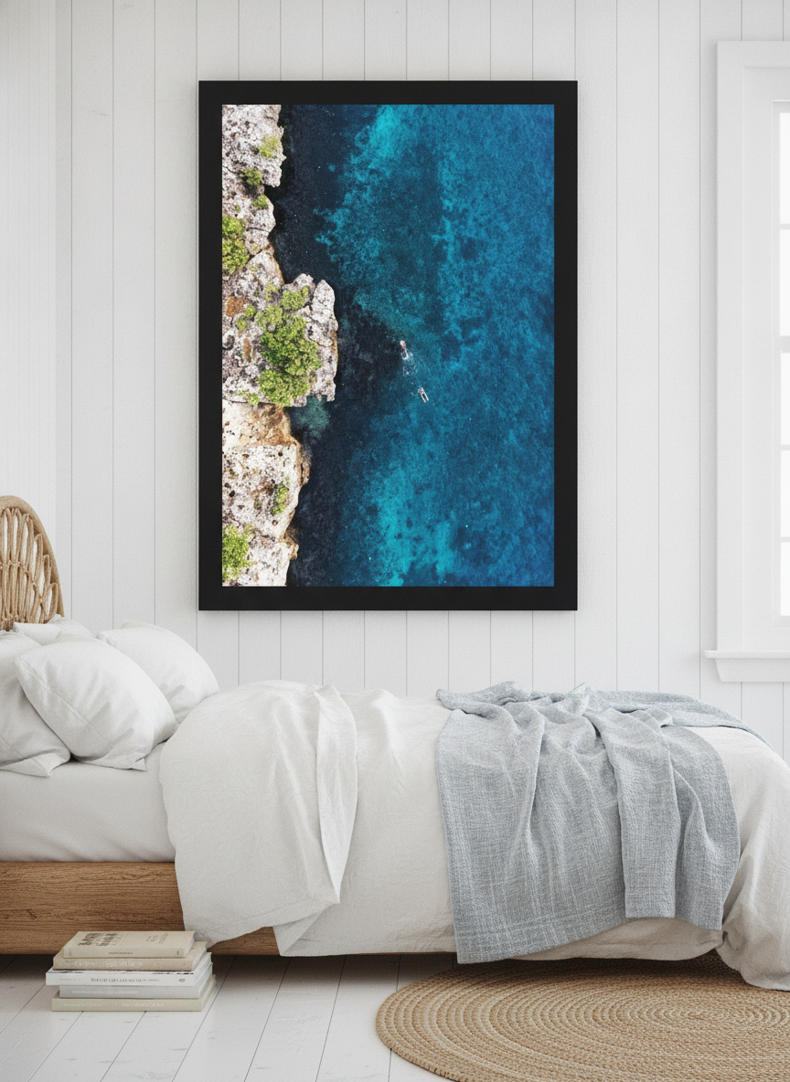 Oversized statement modern wall art print styled on the wall in a coastal bedroom