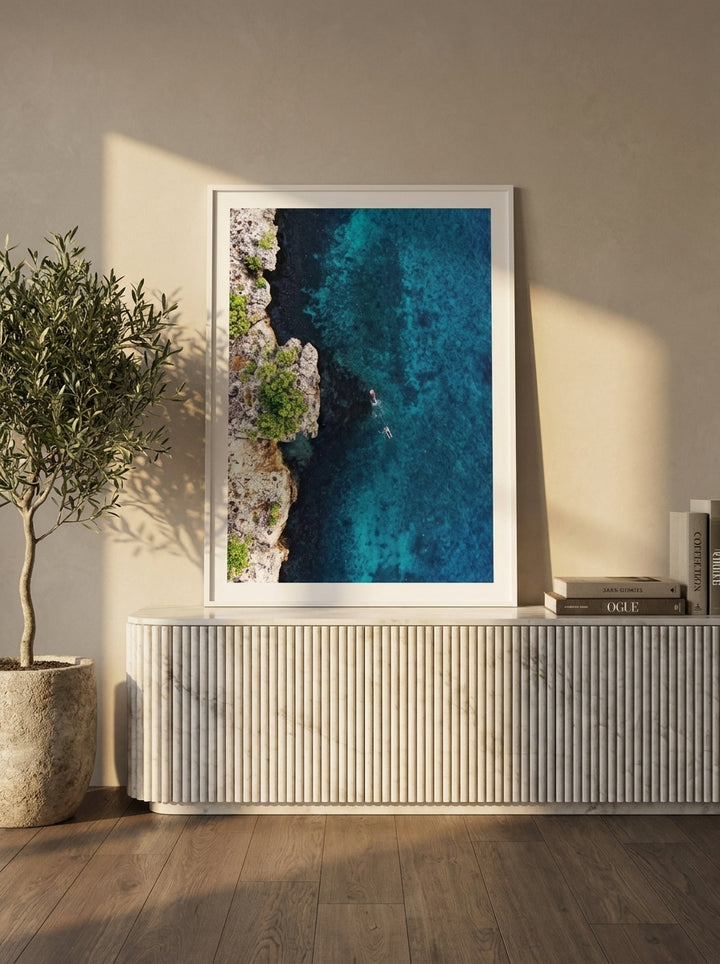 Modern wall art print standing on a sideboard in a luxe living room
