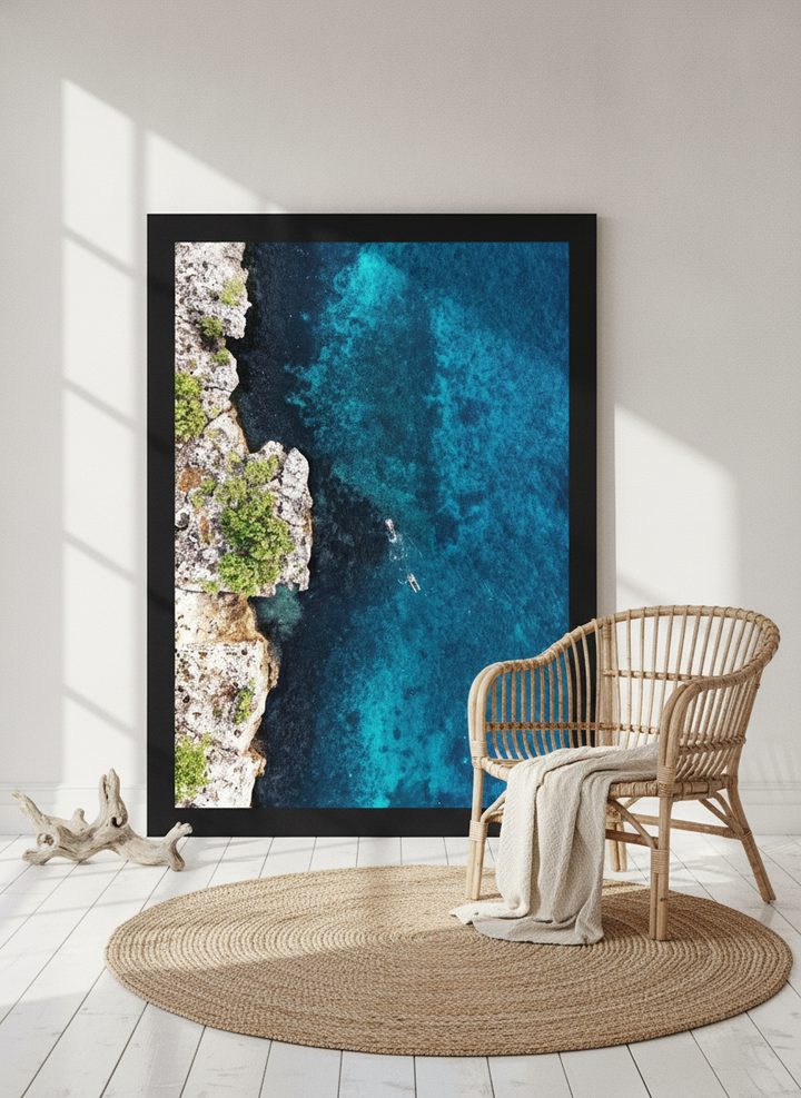 Oversized statement modern wall art print leaning against the wall in a coastal dining room