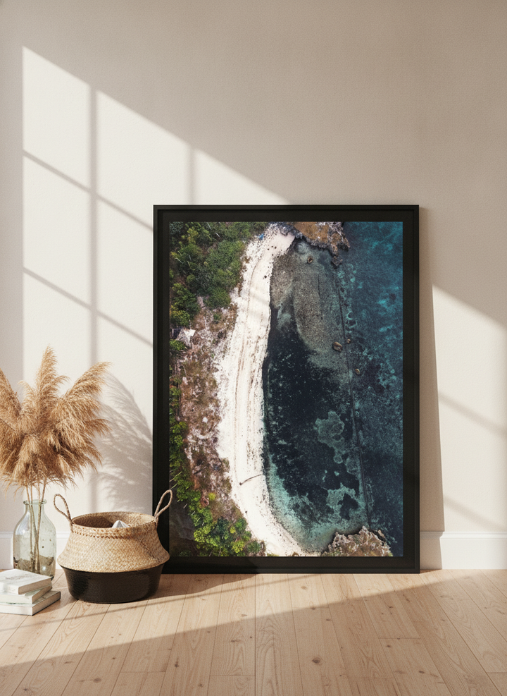 Oversized statement modern wall art print leaning against the wall in a coastal bedroom