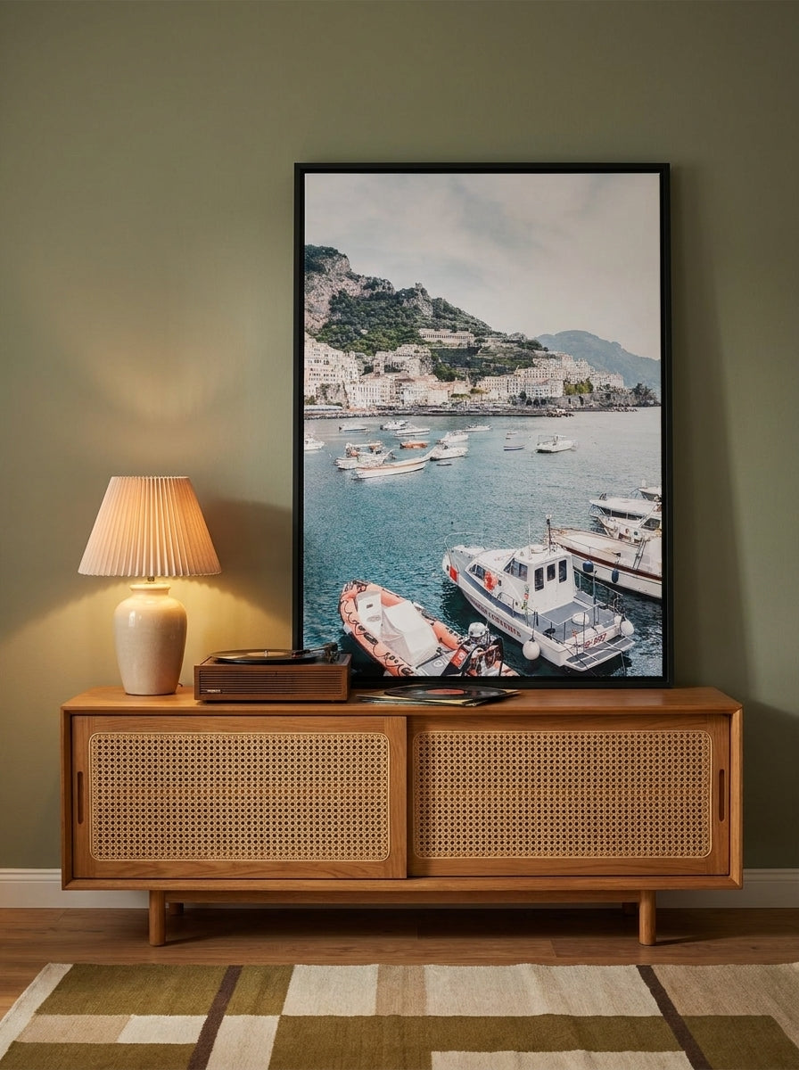Canvas wall art with a black surround standing on a sideboard in a mid-century home office