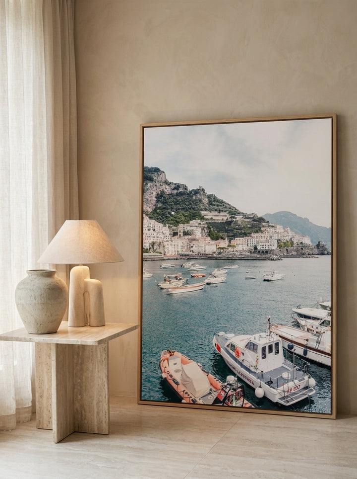 Oversized statement canvas wall art with a natural timber surround leaning against the wall in a luxe dining room